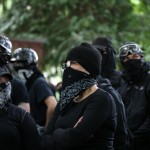 Antifa members gather at a rally held by Patriot Prayer in Portland, Ore., on Saturday, June 30, 2018. Police dispersed clashing protesters as problems occurred when the two opposing protest groups — Patriot Prayer and antifa — took to the streets. 
(Mark Graves / The Oregonian via AP)