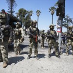 Federal agents stage at MacArthur Park Monday, July 7, 2025, in Los Angeles.
 (Damian Dovarganes / AP Photo)