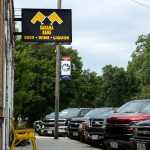 Cars and trucks line the street outside of the Banana Rams bar in Hordville. In eight years, the small business has grown in regional popularity and routinely attracts a crowd of locals from throughout Hamilton County. 
(Pierce Gentry / Flatwater Free Press)