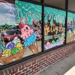 Smiling ice creams painted on the windows of Betty Rae’s Ice Cream just off of 156th and Dodge in west Omaha. 
(Austin Petak / The Daily Record)