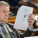 State Sen. Stan Clouse of Kearney reads the voter initiative packet from 2022 that led to voter-approved increases to the state’s minimum wage, March 31, 2025.
(Zach Wendling / Nebraska Examiner)
