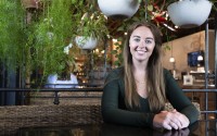 Maddie Hall sits for a portrait at the Mill in Omaha. Hall worries about being tied down by a mortgage, and thinks the flexibility of an apartment is the best fit for her.
(Lily Smith / Flatwater Free Press)