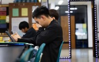 Marco Gutiérrez puts his hand to his face as he works on a study guide in biology class at Schuyler Central High School. 
(Rebecca S. Gratz / Flatwater Free Press)