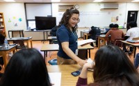 Dorina Ramos passes out a worksheet while teaching a lesson in a physical science class in Schuyler, Neb., on May 2, 2025. A group of teachers from the Philippines moved to Schuyler to teach under H-1B visas this year.
(Rebecca S. Gratz / Flatwater Free Press)
