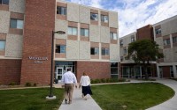 Chris Tonniges (left) CEO of Lutheran Family Services, and Stephanie Gardeman, director of the Root and Rise Program, walk into Mickelsen Hall on the former Dana College campus Friday, Sept. 12, 2025, in Blair, Neb. 
(Rebecca S. Gratz / Nebraska Examiner)