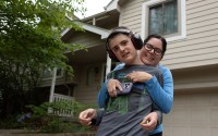 Teddy Gleason leans into a hug with his mother Angela outside their northwest Omaha home on Friday, May 23, 2025. Teddy, 13, will start eighth grade at Omaha’s Davis Middle School in the fall. 
(Liz McCue / Flatwater Free Press)