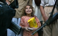An Iraqi girl holds a packet of humanitarian food aid given by U.S. Army medics from the 26 Forward Support Battalion in the countryside outside Fallujah, Iraq Wednesday, July 9, 2003.
(John Moore / AP Photo)