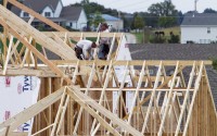 Builders work on a home in Omaha, Neb. ( Nati Harnik / AP Photo)