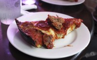 A slice of deep-dish pizza is shown at Pequod's in Chicago Sept. 5, 2014. Chicago is one of a handful of cities across the country, like Boston, Milwaukee and New York, with companies that offer tours of the local pizza scene.
 (Caryn Rousseau / AP Photo)