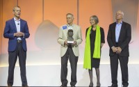 Greg Penner (left) board chairman, speaks alongside Jim Walton, Alice Walton and Rob Walton for the presentation of the Sam Walton Award during the Walmart shareholders meeting Friday, June 2, 2017, at Bud Walton Arena in Fayetteville, Ark.
 (Jason Ivester / The Northwest Arkansas Democrat-Gazette via AP)