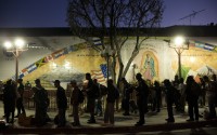 Homeless people wait in line for a meal served by a community organization outside Our Lady Queen of Angels Catholic Church Thursday, Sept. 21, 2017, in Los Angeles. A homeless crisis of unprecedented proportions is rocking the West Coast, and its victims are being left behind by the very things that mark the region's success: soaring housing costs, rock-bottom vacancy rates and a roaring economy that waits for no one. 
(Jae C. Hong / AP Photo)