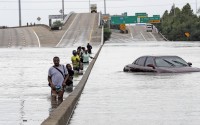Evacuees wade through floodwaters from Tropical Storm Harvey on a section of Interstate 610 in Houston. Houston area officials expressed shock and anger on Friday, May 21, 2021, after learning that their communities, which suffered the brunt of damage from Hurricane Harvey, would be getting a fraction of $1 billion that Texas is awarding as part of an initial distribution of federal funding given to the state for flood mitigation. 
(David J. Phillip / AP Photo)