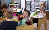 Preschoolers eat lunch at a day care center in Mountlake Terrace, Wash. Child care centers once operated under the promise that it would always be there when parents have to work. Now, each teacher resignation, coronavirus exposure, and day care center closure reveals an industry on the brink, with wide-reaching implications for an entire economy's workforce. 
(Elaine Thompson / AP Photo)