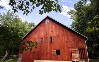 A barn that houses birds from the Raptor Advocacy Rehabilitation and Education Group at Two Horse Farm is seen. Johnson County purchased Two Horse Farm from Erin Melloy and her husband Brian this year and is already preparing the woodlands, farmstead and prairies for public use. (Joseph Cress / Iowa City Press-Citizen via AP Photo)