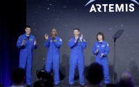 From left, Jeremy Hansen, Victor Glover, Reid Wiseman and Christina Hammock Koch, celebrate on stage as they are announced as the Artemis II crew during a NASA ceremony naming the four astronauts who will fly around the moon by the end of next year, at a ceremony held in the NASA hangar at Ellington airport Monday, April 3, 2023, in Houston. This crew will not land or even go into lunar orbit.  (Michael Wyke / AP Photo)