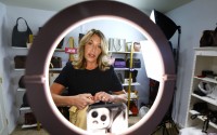 Deborah Mayer works on a livestream on TikTok on Wednesday, March 21, 2024, in Freehold, N.J. Mayer has sold new and pre-owned handbags and other designer goods out of her New Jersey home for 16 years. Early last year, TikTok recruited her business for the live component of TikTok Shop. 
(Noah K. Murray / AP Photo)