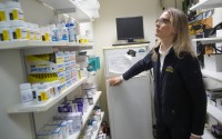 Licensed veterinary technician Jeanine Lunz looks over medical supplies at the City Pets office before leaving for a house call with Dr. Amy Attas, Tuesday, April 23, 2024, in New York. 
(Mary Altaffer / AP Photo)