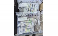 These photos supplied by the U.S. Attorney's Office for Minnesota show cash and a bag that was left at the home of a juror in a massive fraud case, June 2, 2024, outside Minneapolis, Minn. Authorities have confiscated cellphones and taken all seven defendants into custody as investigators try to determine who attempted to bribe the juror to acquit them on charges of stealing more than $40 million from a program meant to feed children during the pandemic. 
(U.S. Attorney's Office for Minnesota via AP)