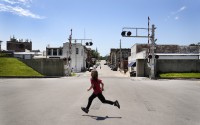 A child runs past an opening in the flood wall protecting downtown Hannibal, Mo., Wednesday, May 22, 2024. The wall protected downtown Hannibal during the flood of 1993 not long after it was completed keeping business open and tourists coming while some homes outside were swamped. 
(Jeff Roberson / AP Photo)