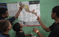 Teenager migrants look at a map of Mexico at the Peace Oasis of the Holy Spirit Amparito shelter in Villahermosa, Mexico, on Friday, June 7, 2024. After the head of Mexico's immigration agency ordered a halt to deportations in December, migrants have been left in limbo as authorities round up migrants across the country and dump them in the southern Mexican cities of Villahermosa and Tapachula. 
(Felix Marquez / AP Photo)