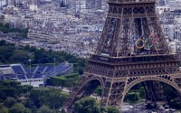 The Olympic rings are seen on the Eiffel Tower in Paris, France, Monday, June 17, 2024. The Champ-de-Mars at left will host the Beach Volleyball and Blind Football at the Paris 2024 Olympic and Paralympic Games. 
(Christophe Ena / AP Photo)