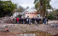 A group of Israelis visit a damaged house following the Oct. 7 Hamas militants attack on Israel in Kibbutz Beeri, southern Israel, on Friday, Jan. 28, 2024. A new kind of tourism has emerged in Israel in the months since Hamas’ Oct. 7 attack. For celebrities, politicians, influencers and others, no trip is complete without a somber visit to the devastated south that absorbed the brunt of the assault near the border with Gaza. 
(Oded Balilty / AP Photo)