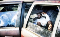 David Clarke, who is suffering homelessness and living in his car, cuddles with his six dogs early morning in a parking lot in Los Angeles on Tuesday, July 9, 2024. 
(Richard Vogel / AP Photo, File)