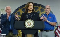 Democratic presidential nominee Vice President Kamala Harris, with Democratic vice presidential nominee Minnesota Gov. Tim Walz (left) and Shawn Fain, President of the UAW (right) speaks at a campaign rally at UAW Local 900, Thursday, August 8, 2024, in Wayne, Mich. 
(Julia Nikhinson / AP Photo)