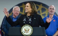 Democratic presidential nominee Vice President Kamala Harris, with Democratic vice presidential nominee Minnesota Gov. Tim Walz (left) and UAW President Shawn Fain, speaks at a campaign rally at UAW Local 900, Thursday, August 8, 2024, in Wayne, Mich. 
(Julia Nikhinson / AP Photo)