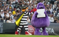 McDonald’s character The Hamburglar (left) steals the base from Grimace during a promotion between the third and fourth innings of a baseball game between the San Diego Padres and Colorado Rockies, Friday, Aug. 16, 2024, in Denver.
(David Zalubowski / AP Photo)