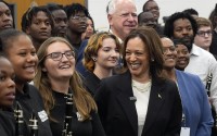 Democratic presidential nominee Vice President Kamala Harris and Democratic vice presidential candidate Minnesota Gov. Tim Walz pose for a photo with marching band members at Liberty County High School in Hinesville, Ga., Wednesday, Aug. 28, 2024. 
(Jacquelyn Martin / AP Photo)