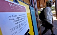 A sign denoting park lodge closures hangs on the door as a guest exits the Bright Angel Lodge, Thursday, Aug. 29, 2024, in Grand Canyon, Ariz. 
(Matt York / AP Photo)