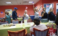 People march in a line as they take part in a multicultural parade at Sunshine Adult Day Center in Bergenfield, N.J., Monday, Aug. 26, 2024. 
(Kena Betancur / AP Photo)
