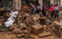 People clean mud from a shop affected by floods in Chiva, Spain, Friday, Nov. 1, 2024. 
(Manu Fernandez / AP Photo)
