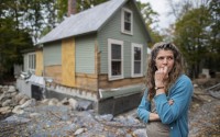 Jenny Mackenzie stands outside her flood-ravaged house in Peacham, Vt. on Sept. 23, 2024.
 (Dmitri Beliakov / AP Photo)