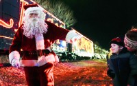 Santa Claus waves to children during a visit of the CSX Holiday Express Thursday, Nov. 21, 2024, in Erwin, Tenn. The railway company held a celebration and concert for the town affected by Hurricane Helene. 
(George Walker IV / AP Photo)
