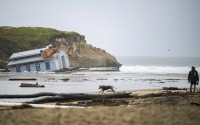 Remnants of a bathroom that fell off the wharf are visible at the mouth of the San Lorenzo River in Santa Cruz, Calif., Tuesday, Dec. 24, 2024. 
(Nic Coury / AP Photo)