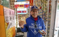 Fidel Lule buys a MegaMillion lottery ticket at Won Won Mini Mart in Chinatown Los Angeles, Thursday, Dec. 26, 2024. 
(Damian Dovarganes / AP Photo)