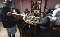 Martha Rosales (right) talks with migrants mainly from Cuba while they wait for an appointment to apply for asylum in the United States through the CBP One app Wednesday, May 22, 2024, in Tijuana, Mexico. 
(Gregory Bull / AP Photo)