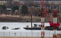 Rescue and salvage crews with cranes work near the wreckage of an American Airlines jet in the Potomac River from Ronald Reagan Washington National Airport, Sunday, Feb. 2, 2025, in Arlington, Va. 
(Jose Luis Magana / AP Photo)