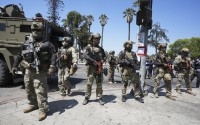 Federal agents stage at MacArthur Park Monday, July 7, 2025, in Los Angeles.
 (Damian Dovarganes / AP Photo)