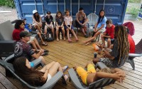 Maui Hero Project and with Kahākūkahi Ocean Academy members talk after their water academy day in Lahaina, Hawaii, on Tuesday, June 10, 2025. 
(Kevin Fujii / Honolulu Civil Beat via AP)
