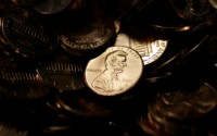 A lone penny is illuminated in a bin of completed pennies at the U.S. Mint in Denver on Aug. 15, 2007. 
(David Zalubowski / AP Photo)
