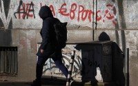 A woman passes by a graffiti reading "No to the euro" altered to "Yes to the euro" in Sofia, Monday, Dec. 29, 2025. 
(Valentina Petrova / AP Photo)