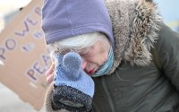 A protester covers their eyes after confronting law enforcement outside the Bishop Henry Whipple Federal Building, Thursday, Jan. 8, 2026, in Minneapolis, Minn. 
(Tom Baker / AP Photo)
