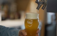 Beer froths after Boston Beer Co. Founder and CEO Jim Koch poured himself a drink at his company headquarters in Boston, Tuesday, July 7, 2026. 
(Rodrique Ngowi / AP Photo)