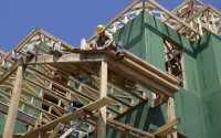Man works on building a house.
(Mel Evans / AP Photo)