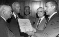 Udall, right, presents the proclamation to, from left, Ned Bush; A. Philip Randolph, President of the Brotherhood of Sleeping Car Porters and Debs Foundation President Patrick Gorman. 
(AP Photo / Tribune Star)