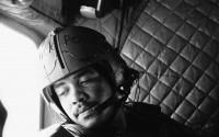 Sergeant G. Sanders from Detroit looks from the window of his Chinook helicopter during a resupply mission, April 24, 1969. Across his helmet he was written with black, pasty color "Black Power". Sanders is a door gunner of a helicopter unit of the 1st Cavalry Division which operates in War Zone C. 
(Horst Faas / AP Photo)