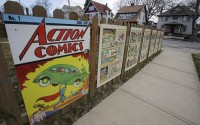 Oversized Superman comic book pages displayed on a fence outside of what was once Joe Shuster's boyhood home in Cleveland. Superman collaborators Jerry Siegel and Shuster lived several blocks apart in the Glenville neighborhood which shaped their lives, dreams for the future and their imagery of the Man of Steel. 
(Tony Dejak / AP Photo)